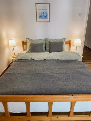 a large bed in a room with two lamps at Cozy place in Larnaka