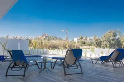 a group of chairs and a table on a patio at Protaras Olivine Villa OL17 in Protaras