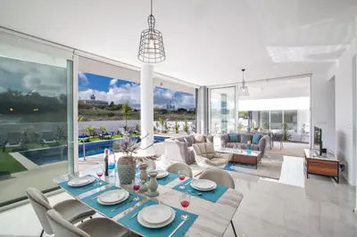 a living room with a dining table and chairs at Olivine 3 Bedroom Villas in Protaras