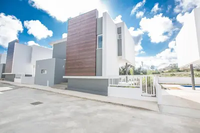 a rendering of a white house with a wooden wall at Olivine 3 Bedroom Villas in Protaras