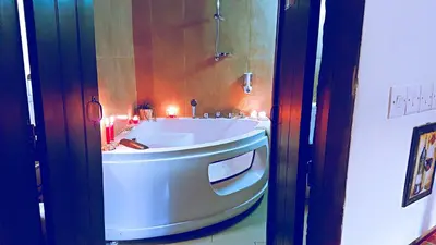 a bathroom with a white tub in a room at Irene's House in Kakopetria