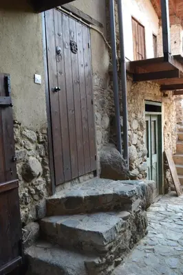 an entrance to a stone building with a wooden door at Irene's House in Kakopetria