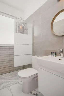 a bathroom with a white toilet and a sink at Protaras Olivia Pearl Villa in Paralimni