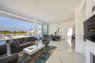 a living room with a couch and a table at Protaras Olivine Pearl in Protaras