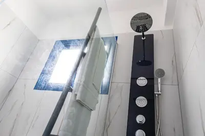 a bathroom with a shower and a towel hanging on the wall at Protaras Villa Nicol 21 in Paralimni