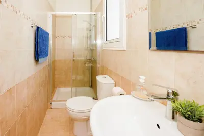 a bathroom with a toilet and a sink and a shower at Villa Blue Sky in Protaras