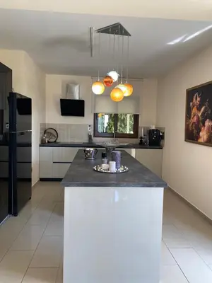 a kitchen with a large island in the middle at Ionion Beachfront Villa in Ayia Napa