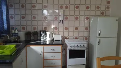 a kitchen with a stove and a white refrigerator at Myriama Apartments in Ayia Napa