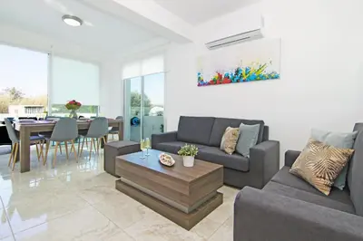 a living room with a couch and a table at Villa Caren in Paralimni