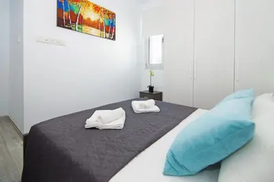 a bedroom with a bed with two towels on it at Villa Caren in Paralimni