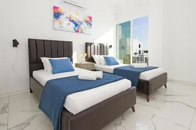 two beds in a room with blue and white at Villa Paradisia in Ayia Napa