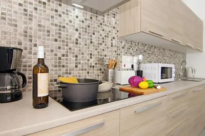 a kitchen with a counter top with a bottle of wine at Villa Amelia in Paralimni