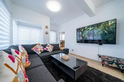 a living room with a couch and a table at Dene Hollow Oroklini in Voroklini