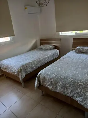 two beds in a room with two windows at Mythical Sands Resort - Maria in Protaras