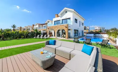 a large white house with a patio and a pool at Serenity Seafront Villa in Ayia Napa