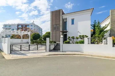 a white house with a gate and a fence at Blue Pelagos Villa in Protaras