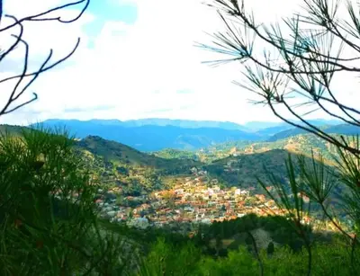 a view of a city from a mountain at Mountain Rose Hotel & Restaurant in Pedoulas