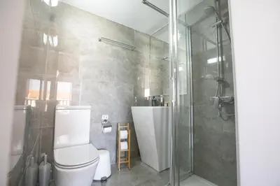 a bathroom with a shower and a toilet and a sink at Tonia Seaview Villas in Protaras