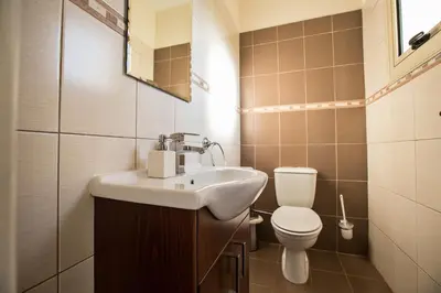 a bathroom with a sink and a toilet at Tonia Seaview Villas in Protaras
