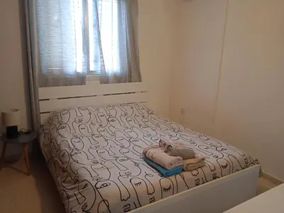 a bedroom with a bed with a pillow and a window at Larnaca, Pervolia 1 bedroom seaside apartment in Pervolia