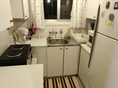 a small kitchen with a sink and a refrigerator at Larnaca, Pervolia 1 bedroom seaside apartment in Pervolia