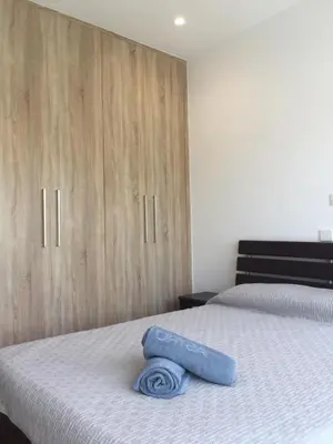 a bed with a blue towel laying on top of it at Modern 2 bedroom Beach Apartment in Limassol