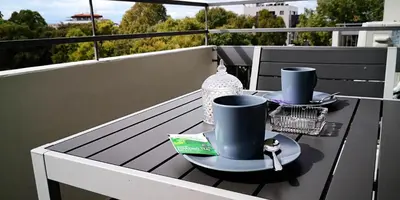 a table on a balcony with two dishes on it at River View Apartment in center Nicosia in Nicosia