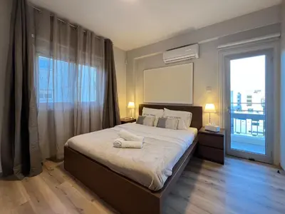 a bedroom with a large bed and a large window at River View Apartment in center Nicosia in Nicosia