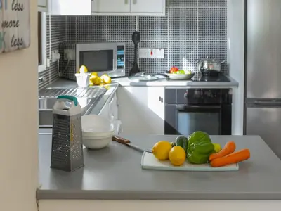 a kitchen with a plate of vegetables on a counter at Protaras Fig Tree Bay Villa Buena in Protaras
