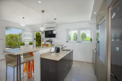 a kitchen with a sink and a counter top at Ayia Thekla Seafront Villa Lavender in Ayia Napa
