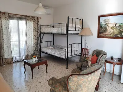 a living room with two bunk beds and a couch at George Houses in Pendakomo