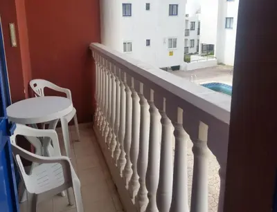a balcony with a table and a table and chairs at Ayia Napa Sun Central in Ayia Napa