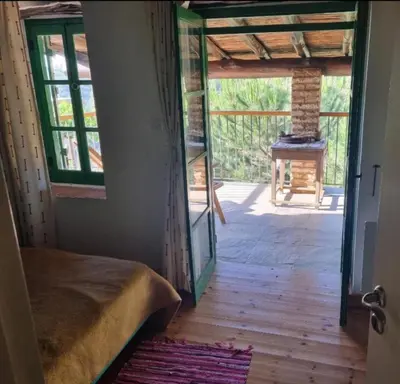 a room with a door leading to a room with a table at Lasmari's Bouquet in Sykopetra