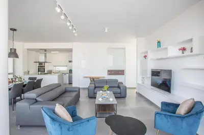a living room with a couch and chairs and a table at Villa Naya in Protaras