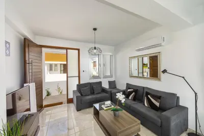 a living room with a couch and a table at Protaras Villa Alasia in Protaras