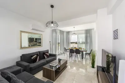 a living room with a couch and a table at Protaras Villa Alasia in Protaras