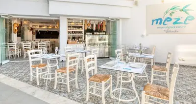 a restaurant with tables and chairs in front of a store at King Jason Protaras - Designed for Adults by Louis Hotels in Protaras