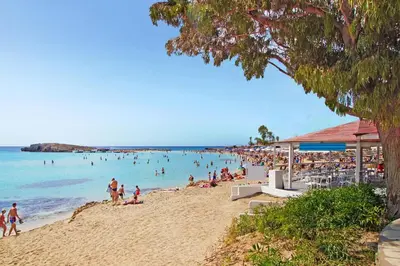 a beach with a lot of people in the water at Villa Katherine - Nissi Beach Area in Ayia Napa