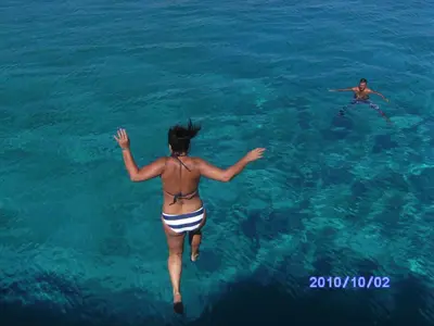 two people are swimming in the water at Luxury Villa - Private Pool and Wifi Perfect location for a holiday in Protaras