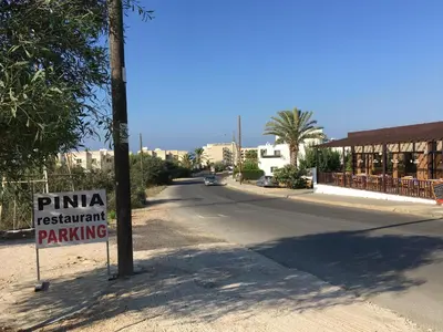 a street with a sign that reads pima restaurant parking at Luxury Villa - Private Pool and Wifi Perfect location for a holiday in Protaras