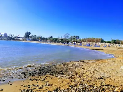 a group of people on a beach with the water at SUNNY HOME in Protaras
