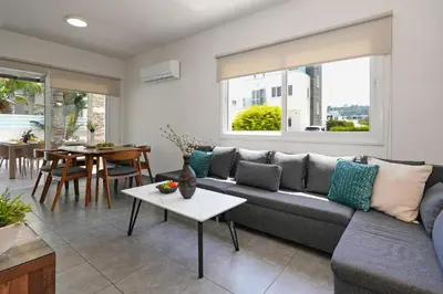 a living room with a couch and a table at Villa Anastasia - Fig Tree Bay Area in Protaras