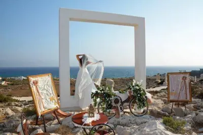 a white altar with a wedding dress in front of the ocean at My Holiday in Ayia Napa