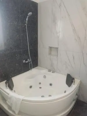 a white bath tub in a bathroom with a shower at Villa Ruby Yiasemina in Ayia Napa