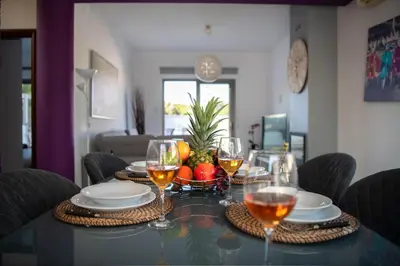 a table with glasses of wine and a bowl of fruit at Villa Ruby Yiasemina in Ayia Napa
