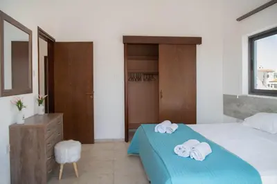 a bedroom with a bed with towels on it at Villa Ruby Yiasemina in Ayia Napa
