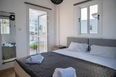 a bedroom with a bed with two towels on it at Villa Ruby Evelyn in Protaras