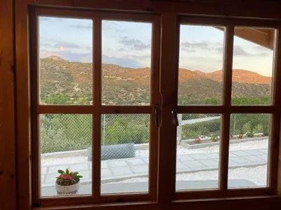 a window with a view of a mountain view at Happy Glamping Cy in Ayios Theodhoros