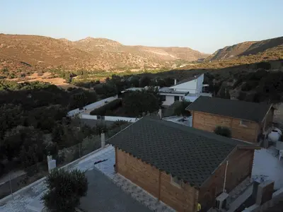 an overhead view of a house with a road and mountains at Happy Glamping Cy in Ayios Theodhoros
