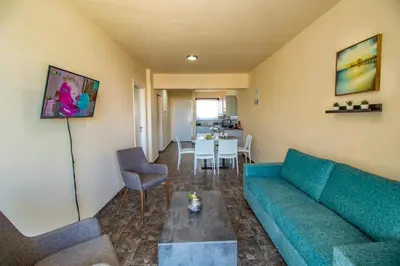 a living room with a couch and a table at Leucolla Hill & Sea in Protaras